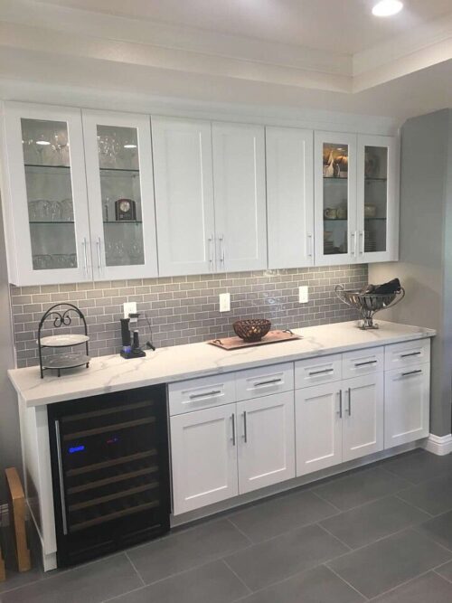 A white kitchen with white cabinets with a floor-to-ceiling dry bar.