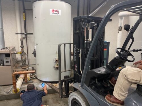 Our team is working a Toyota forklift to remove the commercial water heater.